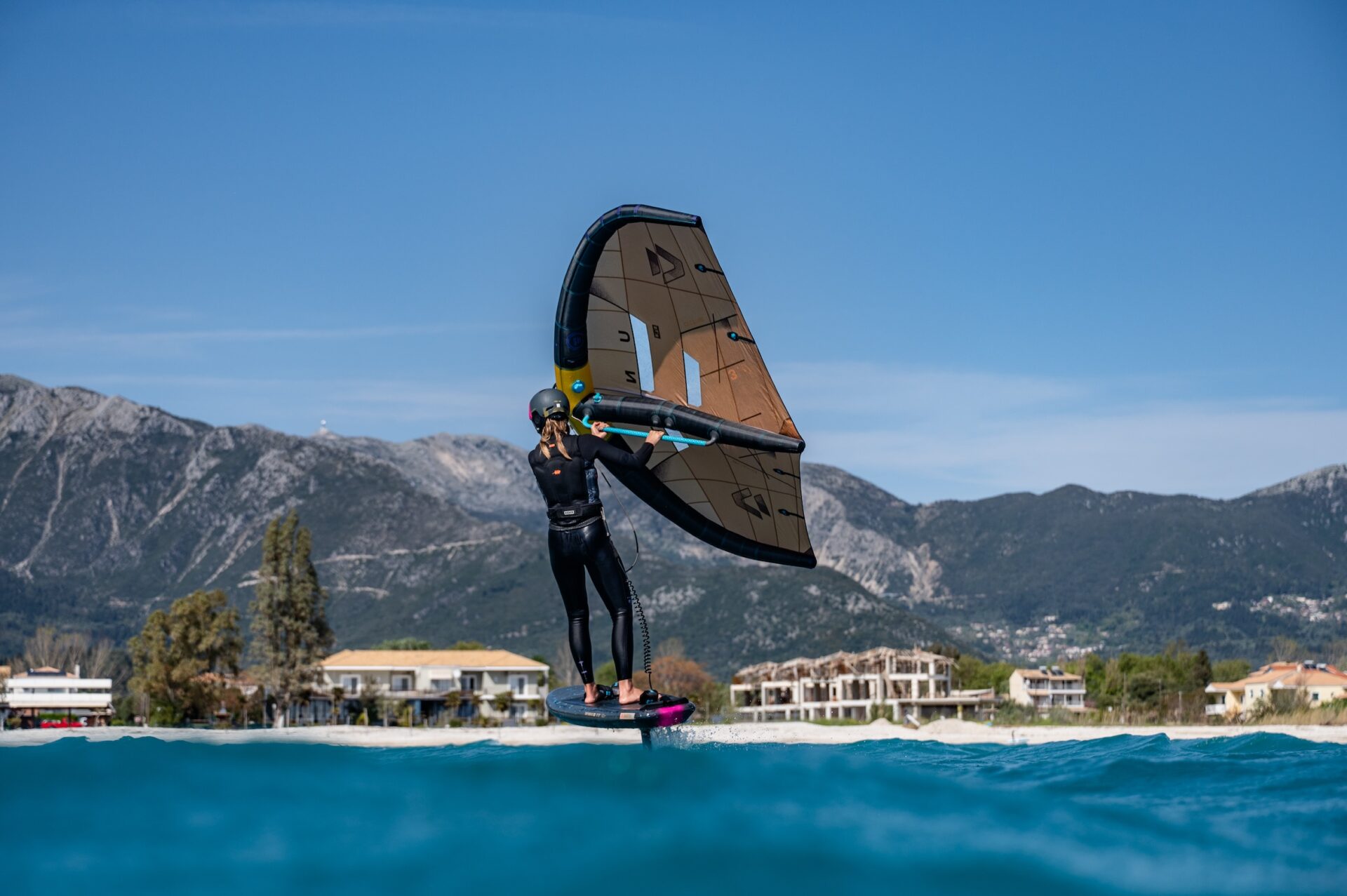 Wing-foiling in front of Vass Beach House in Vassiliki, Lefkada, Greece