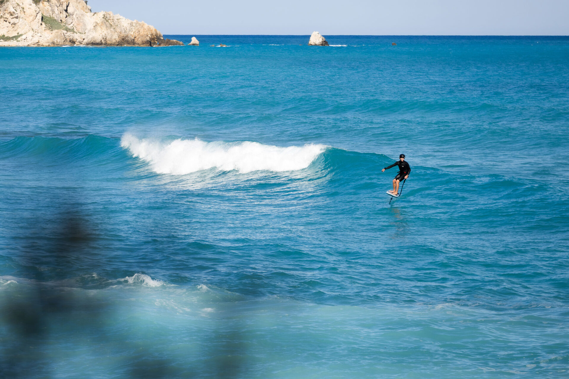 max-rowe-foiling-waves-vasiliki-lefkada Co-founder of Vass Beach House Max Rowe foiling waves in Vassiliki on hired gear from the Wing-foil rental in Vassiliki