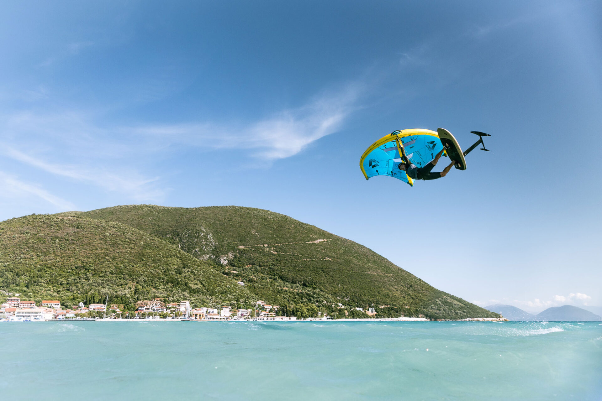 max-rowe-wing-foil-raley-vasiliki-lefkada Co-founder of Vass Beach House Max Rowe jumping wing-foiling in Vassiliki on hired gear from the Wing-foil rental in Vassiliki