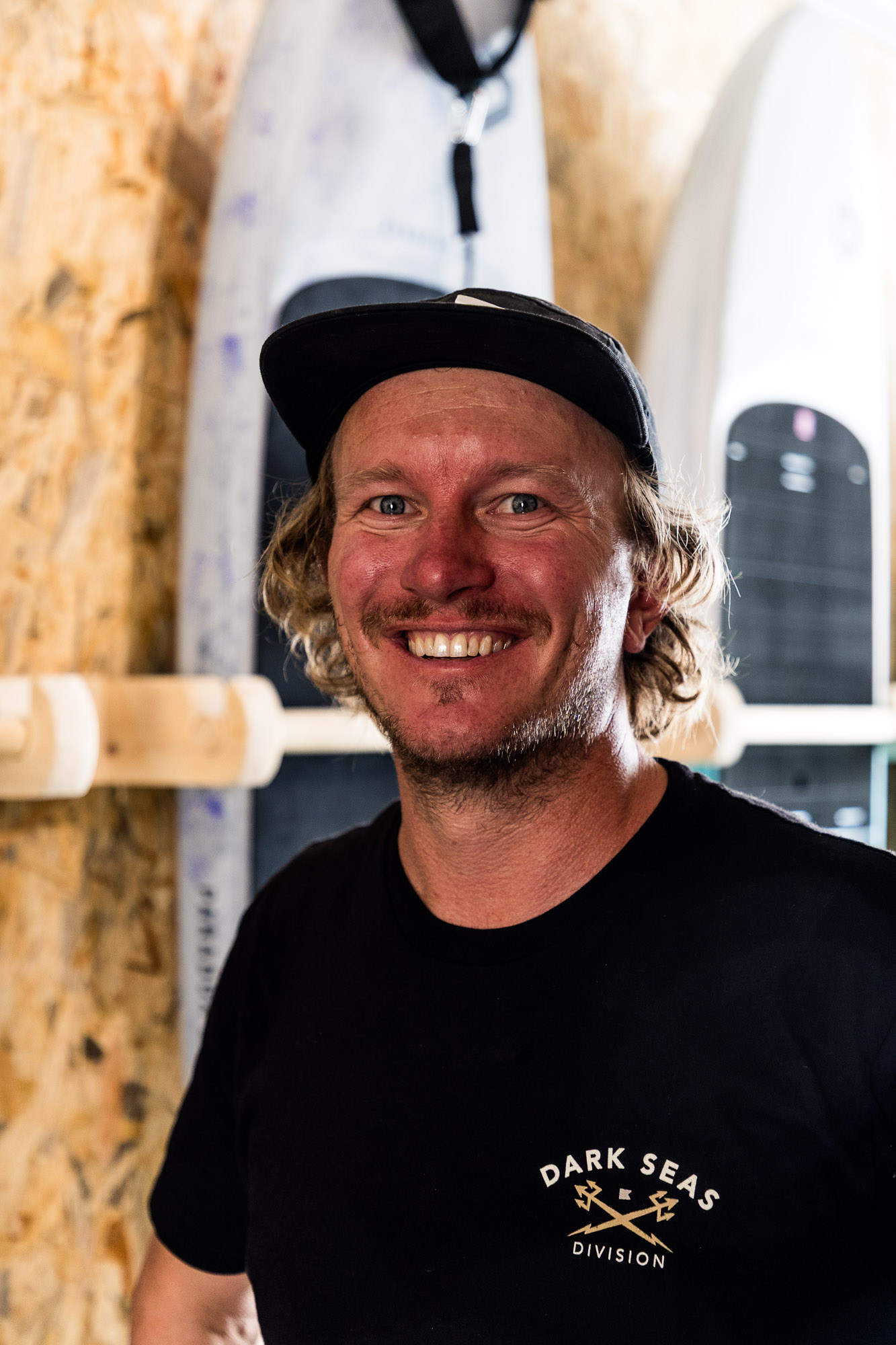Max Rowe posing for a portrait photo at Vass beach house