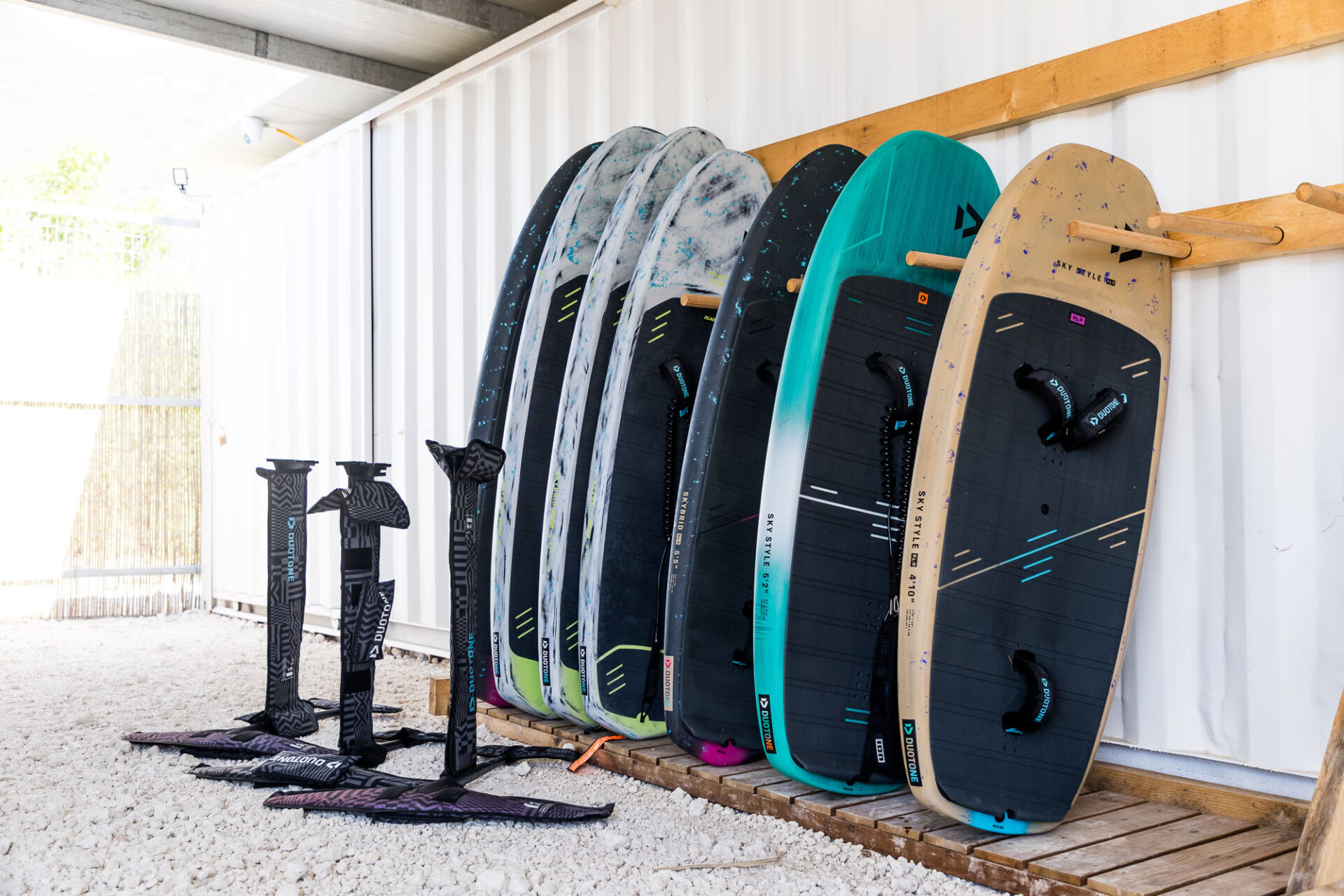 Board rack filled with Duotone boards and foils sat in front of the boards